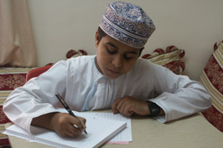 A boy writing at home.