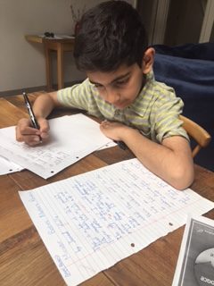 Secondary school boy focusing on his handwriting
